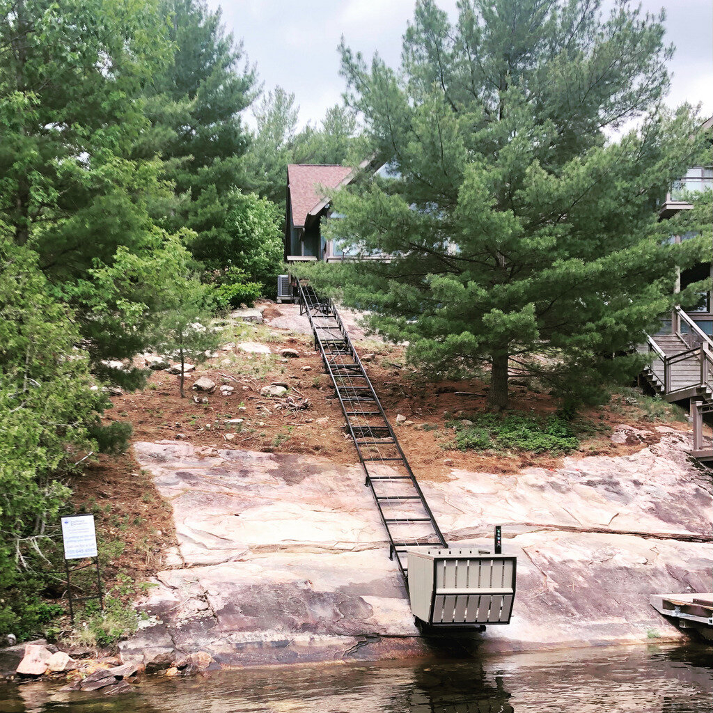 The track runs along this unused side yard and is set so that the removable dock, when installed, just fills the gap. The upper station is off the side of the full-length front deck.