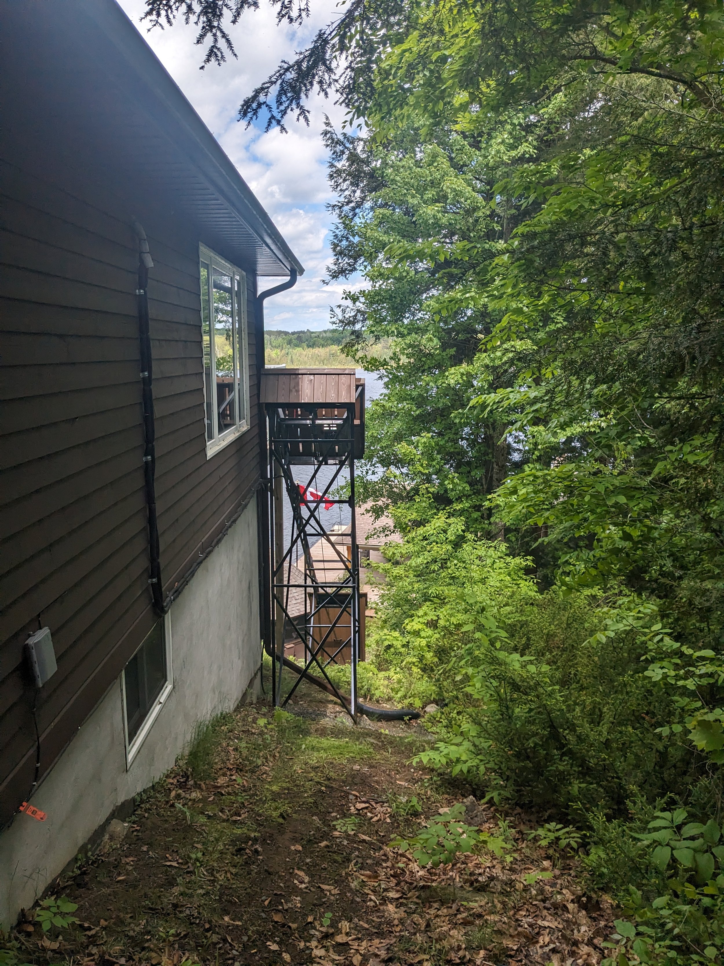 We used our gantry crane to lift the first 20-foot, 385-pound section of track 10 feet off the ground. Custom jigs let us position the track with high accuracy across three spatial and three angular dimensions. Once aligned, support legs held it securely in place. The lift is equipped with an interlocked safety gate at the top station, preventing access to the track when the lift is out of the station.