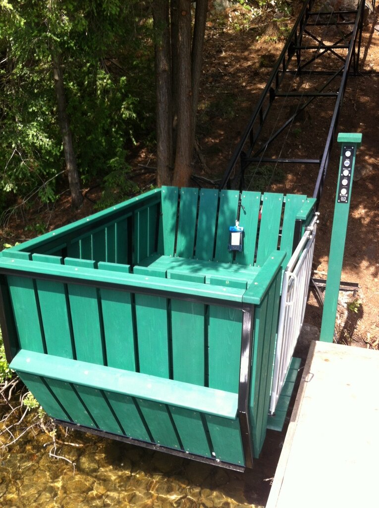 We set the track so the existing dock could serve as the lower station without structural changes, other than adding a button box. Instead of trudging up the stairs loaded with luggage and supplies, everyone gets a quiet ride to the top and a fine view on the way.