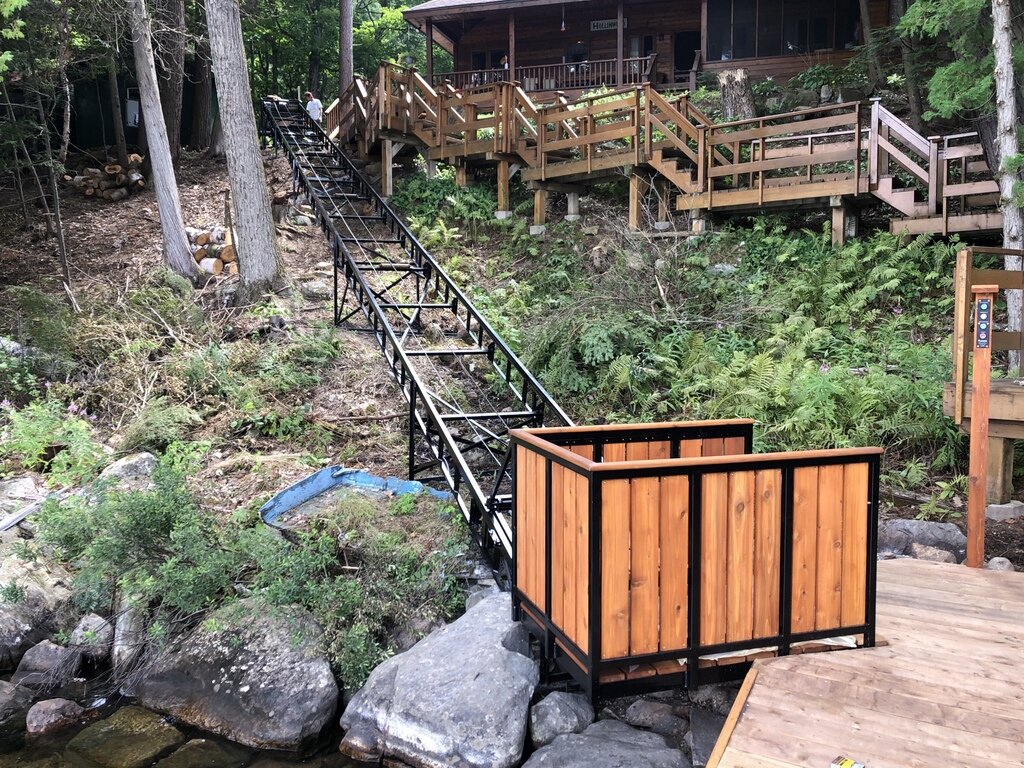 An overview from the dock to the cottage. As the foliage on either side of the track recovers from construction, the track will be camouflaged from the water.