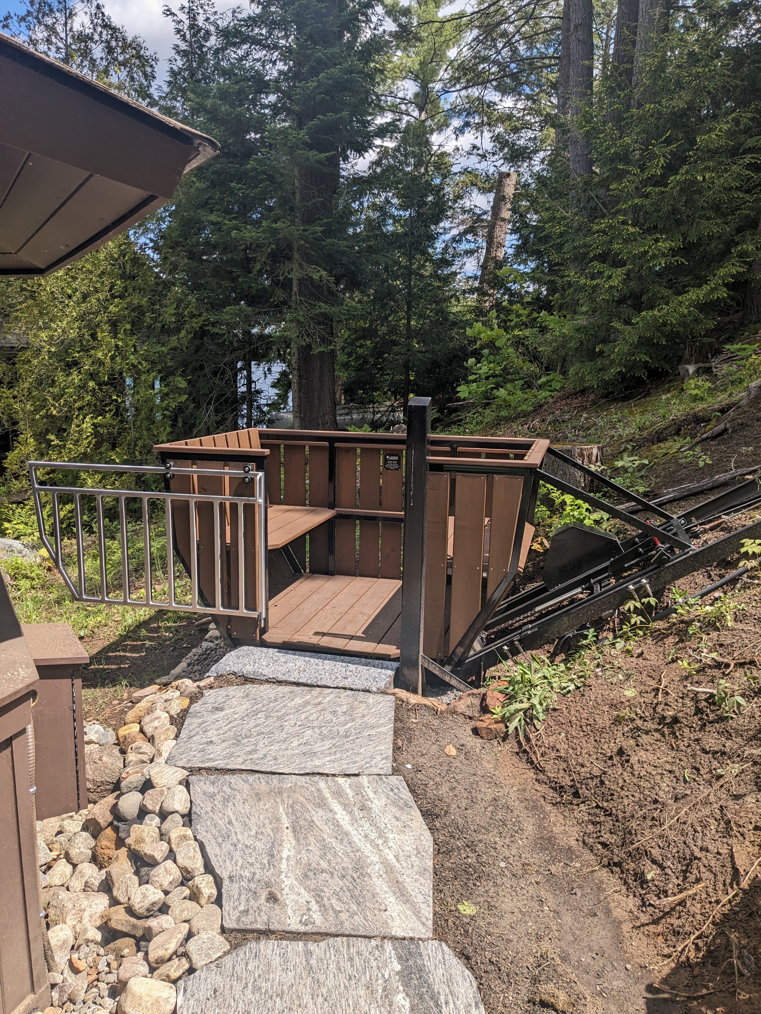 The lower station sits beside an existing gazebo. To bring the lift as close to the ground and the structure as possible, we switched to shallow track for the final 20 feet.