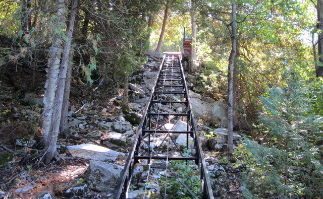 Looking up the track. The light levels in these photos make it clear the track runs through a part of the yard the cottagers never used. Before we arrived, the owner moved some of the rock to prevent later damage to the lift.