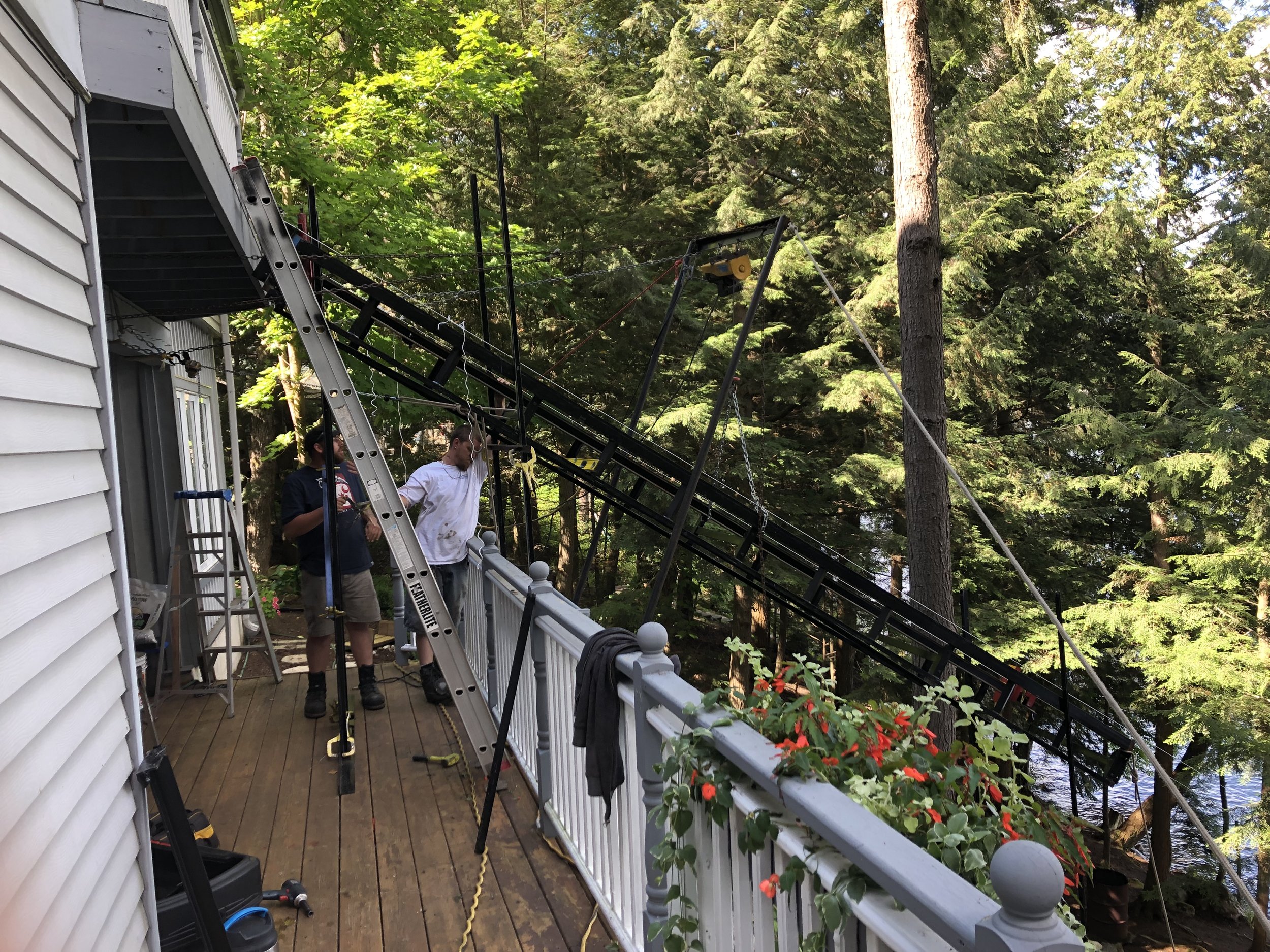The car door had to open onto the deck, so we set the car sideways to the track—something we had seen but never done before—and on top of the dolly. Setting the track was demanding: it had to be as close to perpendicular to the leading edge of the deck as possible, and positioned so the car floor would rest level with and an inch away from the deck. The fit was so tight that we customized the dolly to attach it to the hoisting cable.