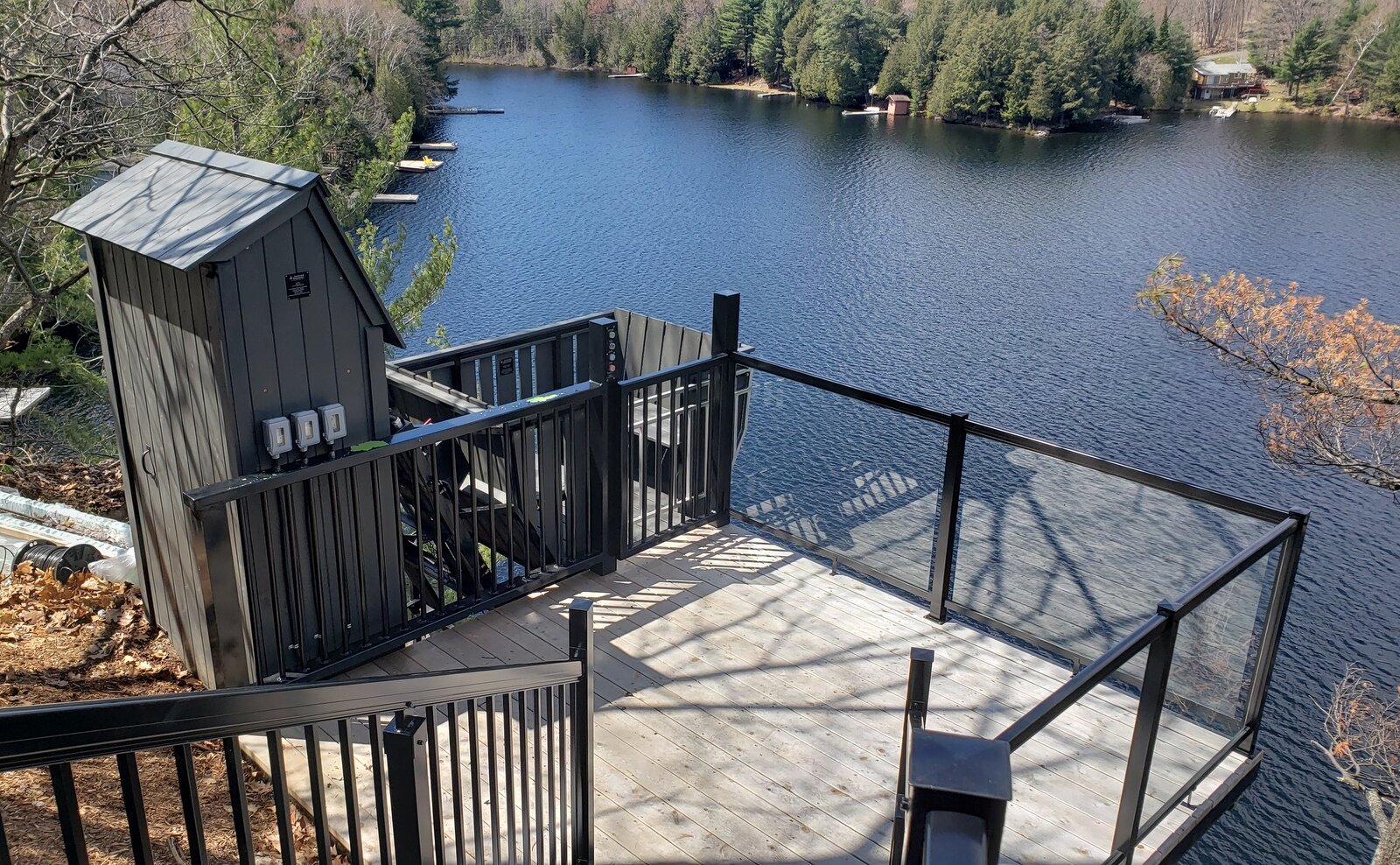 The completed lift and upper-station gate platform have a significant wow factor. All the hoisting hardware sits inside the housing attached to the track. Premier Docks built the upper-station platform, railings, and gate, and mechanically integrated the button-box plate and the gate interlock we left for them.