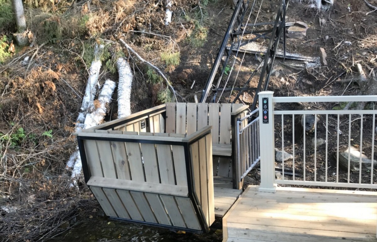 The lower station connects to a previously unused corner of the boathouse deck. The craftsmen at Lovegrove designed and modified the deck and added the railing, and we integrated the control buttons into the railing post.