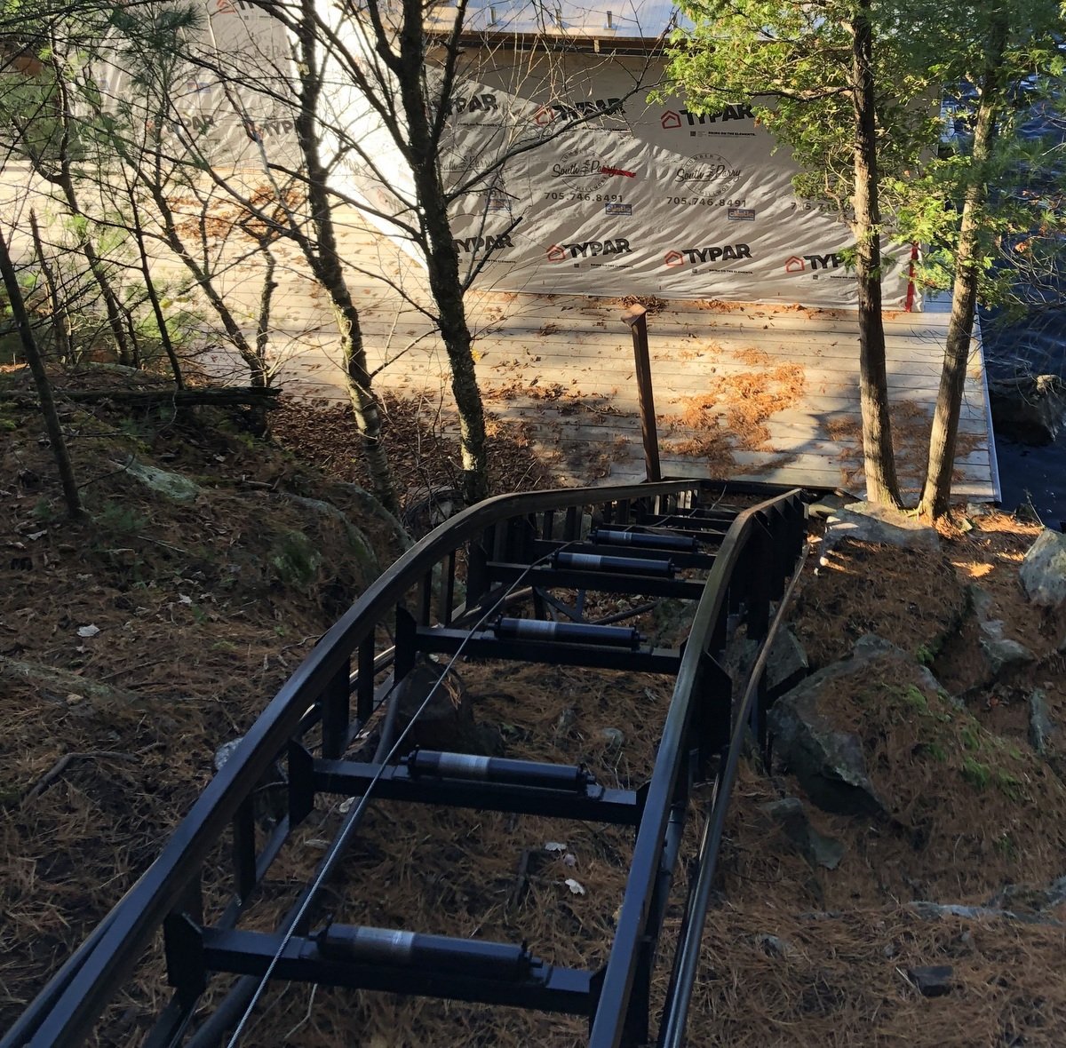 The curve. The pipe track on the outside of the regular track works with the levelling rigger on the car to keep the car floor level throughout the ride.