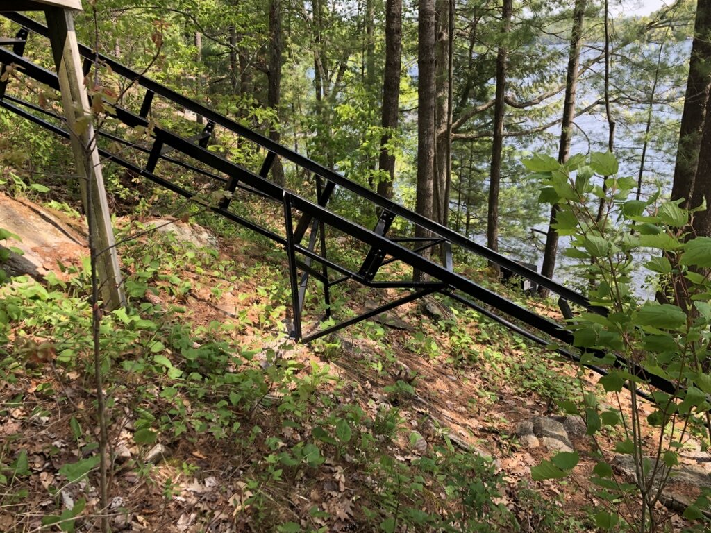 To keep the track low to the hill and as far off the dock as possible, we transitioned from regular to light track 45 feet from the bottom. The light track needs legs every 10 feet instead of every 20.